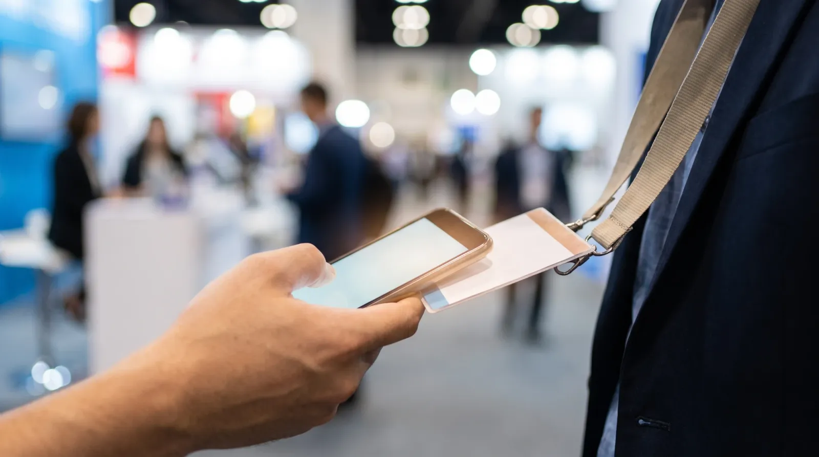 Tapping a smartphone against a staff lanyard badge